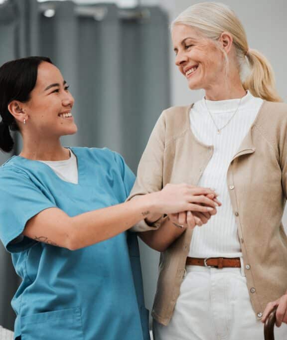 a support care worker helping an elderly woman getting around