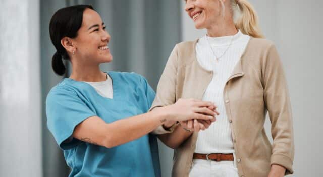 a support care worker helping an elderly woman getting around