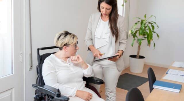 disability worker caring for an elderly lady in a wheelchair