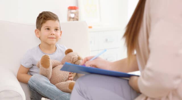 a little boy getting taught in a classroom